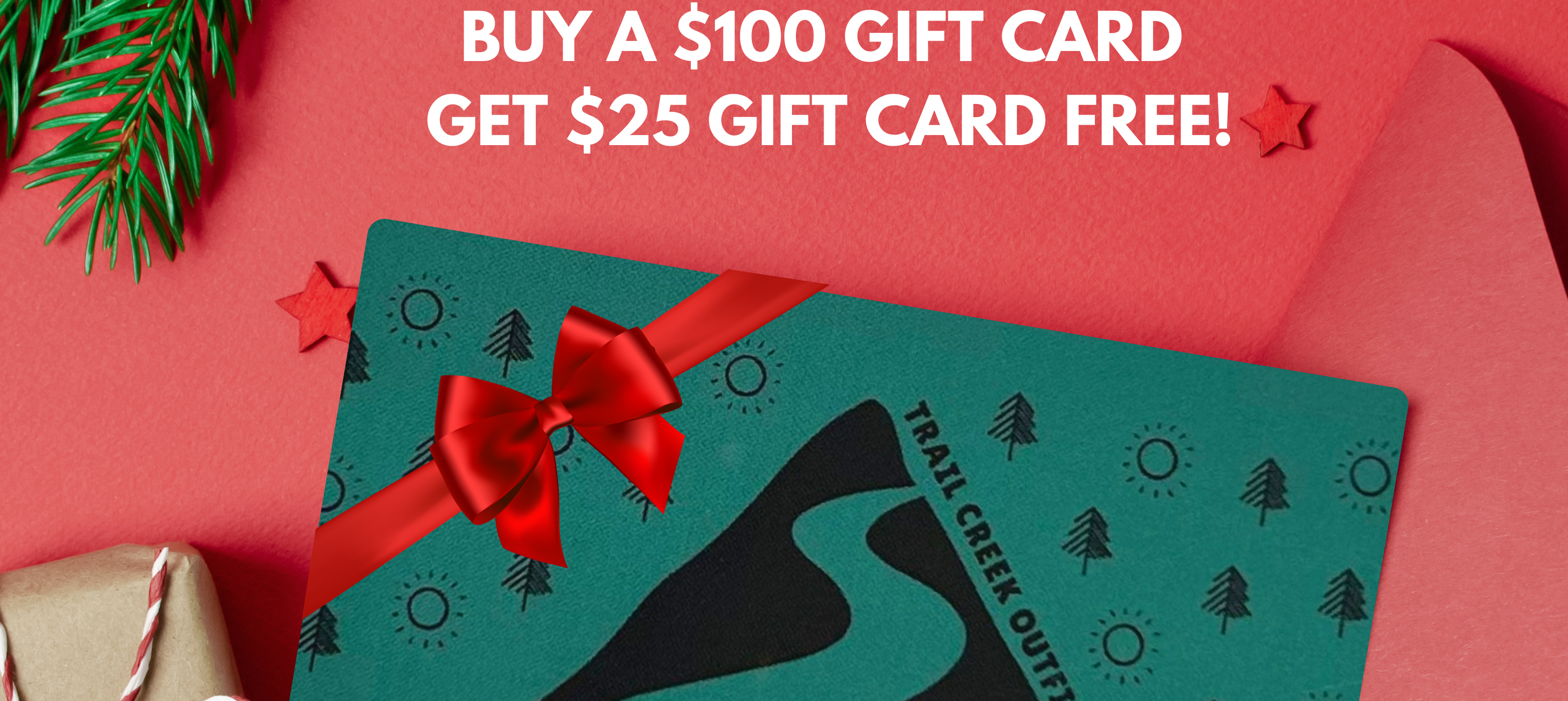Green gift card with red bow on a red background with Christmas decorations